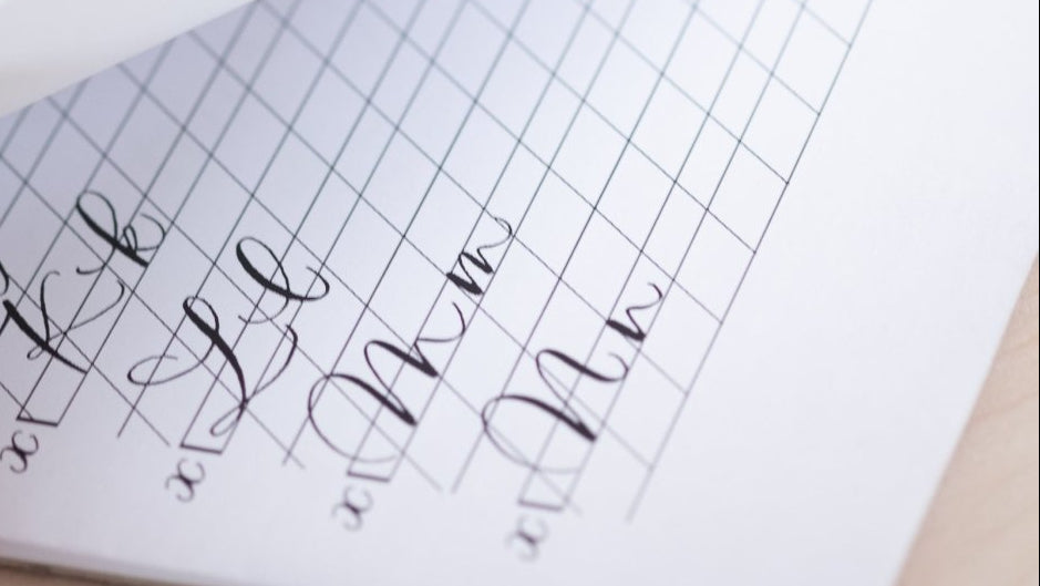 Handwritten notes on a lined notebook page with a pen and paper in the background.